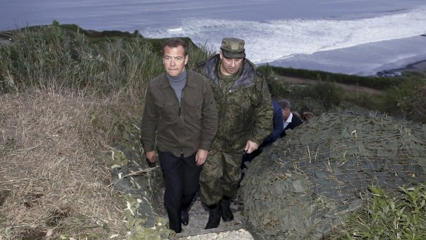 Russia's Prime Minister Dmitry Medvedev inspects a machine gun regiment during his visit to Iturup Island.