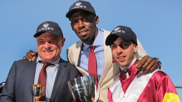 Bolt from the blue: (From left) Lee Curtis celebrates the memorable Oaks win with jockey Brenton Avdulla and VRC guest Usain Bolt.