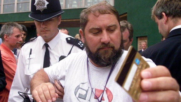 Troublemaker: Damir Dokic, father of Australian tennis player Jelena Dokic, is escorted by police from the media balcony at Wimbledon in 2000.