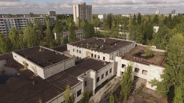 An abandoned restaurant, supermarket and apartment buildings stand overgrown with trees in Pripyat, Ukraine, where the former Chernobyl nuclear power reactor exploded in 1986. 