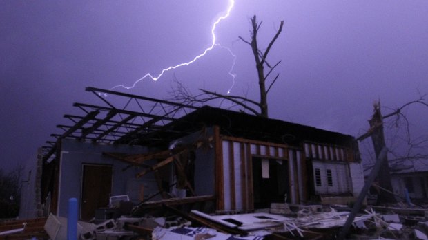 Lightning illuminates a house after a tornado touched down in Jefferson County, Alabama last week.