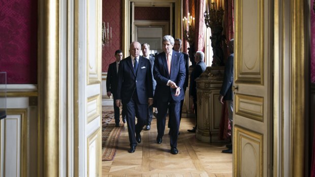 French Foreign Affairs Minister Laurent Fabius and US State Secretary John Kerry arrive at the French Foreign Affairs Ministry for talks on Saturday.