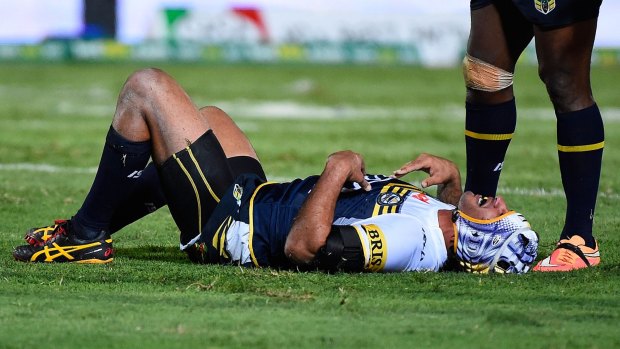 Laid out:  Johnathan Thurston gets his breath back after a shocking double tackle.