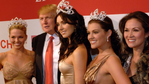 Donald Trump posing with women from several of the pageants he owned in 2006. 