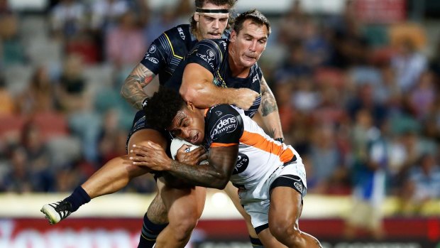 Heavy attention: Kevin Naiqama of the Tigers is tackled by the Cowboys defence.