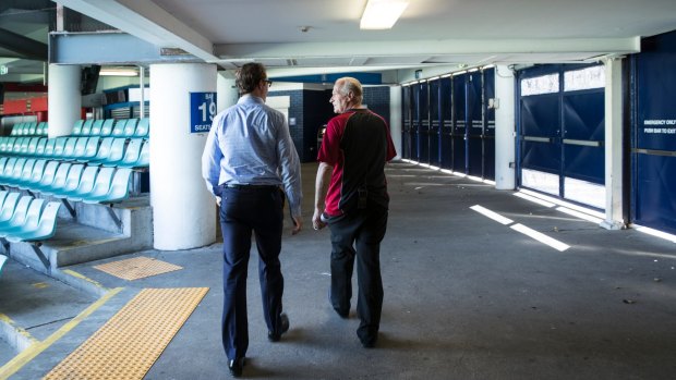 Phil Heads (left), communications director at the SCG Trust, shows the narrowness of the concourse at Allianz, which has been identified as a safety concern.