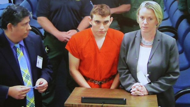 A video monitor shows school shooting suspect Nikolas Cruz, centre, making an appearance before Judge Kim Theresa Mollica in Broward County Court on Thursday.