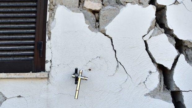 A crucifix hangs on the wall of a damaged house in Amatrice, Italy. 
