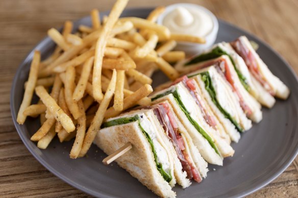 A nod to the past: Truffled chicken club sandwich with fries.