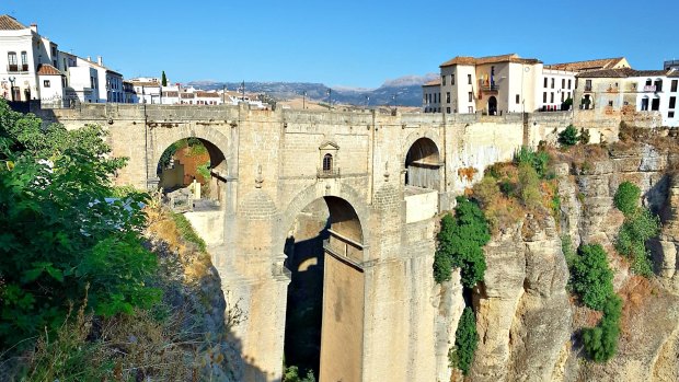 Beautiful Ronda, in the Malaga province of Spain, is set high on the clifftops over the El Tajo gorge.  The 18th century Puente Nuevo ("new") bridge separates the old town from the new.