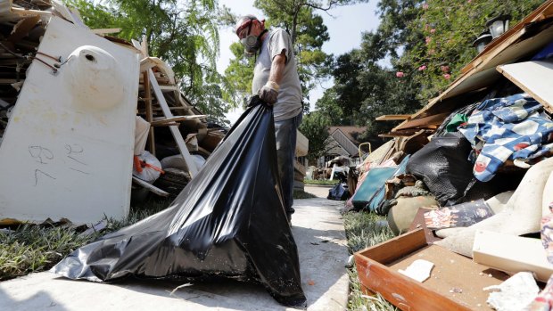Volunteer Mark Staerkel removes debris from a home destroyed by floodwaters in the aftermath of Hurricane Harvey.