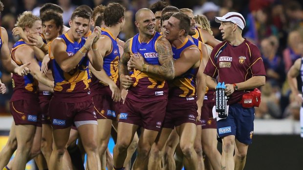 BRISBANE, AUSTRALIA - JUNE 23:  Ashley McGrath of the Lions celebrates with team mates after kicking the winning goal during the round 13 AFL match between the Brisbane Lions and the Geelong Cats at The Gabba on June 23, 2013 in Brisbane, Australia.  (Photo by Chris Hyde/Getty Images)