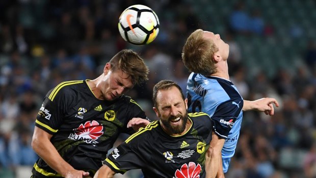 Outnumbered: Dylan Fox and Andrew Durante of the Phoenix challenge Sydney FC's Matt Simon for the ball.