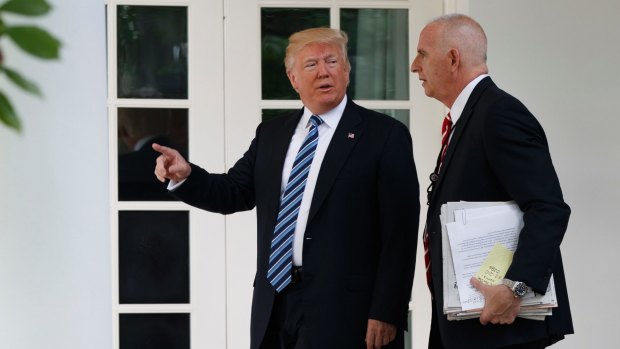 Donald Trump walks with protection officer Keith Schiller to the Oval Office.