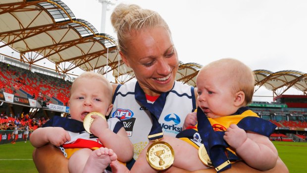 Hands are full: Erin Phillips celebrates with her twins Blake and Brooklyn after the grand final triumph.