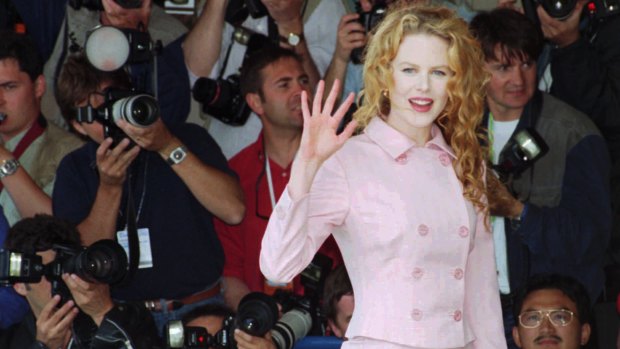 Nicole Kidman, waves to photographers before her press conference for the film " To Die For".
