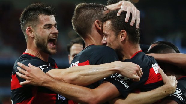 Luxury import: Oriol Riera and the Wanderers celebrate opening the scoring.