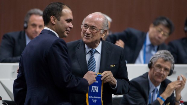 Jordanian Prince Ali bin-al Hussein and FIFA president Sepp Blatter shake hands before the vote.