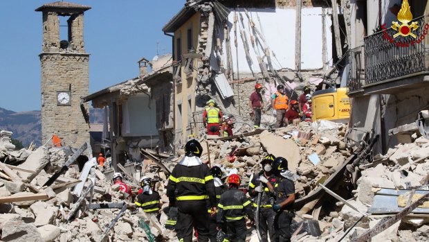 Rescuers work amid collapsed building in Amatrice.