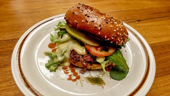 Smoked pulled beef bun with tomato, pickle, cheese, lettuce and horseradish mayo.