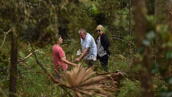 Mark Leveson, centre, with his wife Faye Leveson and son Peter Leveson flag spots in the Royal National Park during the search for Matthew Leveson's body. 