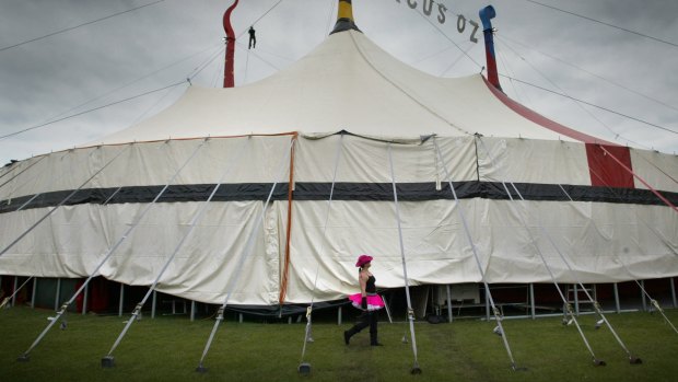 Performer Mel Fyfe walks around the Circus Oz tent.