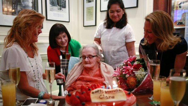 Clare Hollingworth, centre, a British former longtime foreign correspondent, is surrounded by friends and admirers at her 105th  birthday party at Hong Kong's Foreign Correspondents' Club in October.