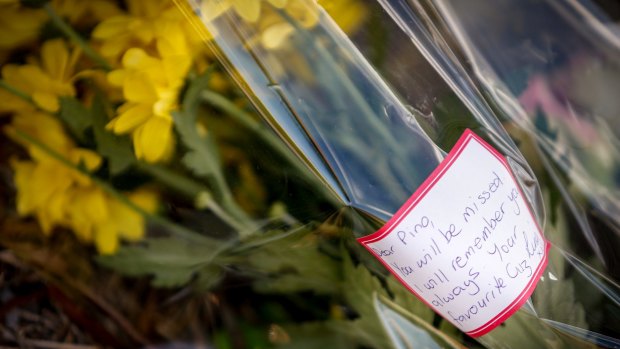 A floral tribute laid for Joseph Acquaro near his Brunswick East cafe.