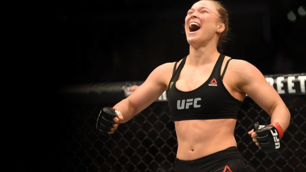 The Mike Tyson of women's UFC, Rousey celebrates her victory.