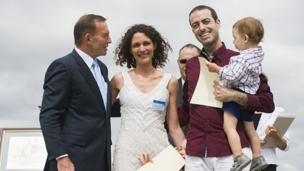 
New Australians are welcomed by Tony Abbott at their citizenship ceremony.


