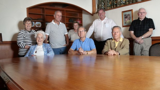 Rear from left, Ilona Kamm, Dieter Kamm, Elvera Lupke, Kevin Bramboeck, Friedhelm Lupke, front from left, Ursula Voege, Klaus Scharrer and Hartmut Schroeder at the Harmonie German Club with the Stammtisch table, which has the names of the foundation board members attached on plaques. 