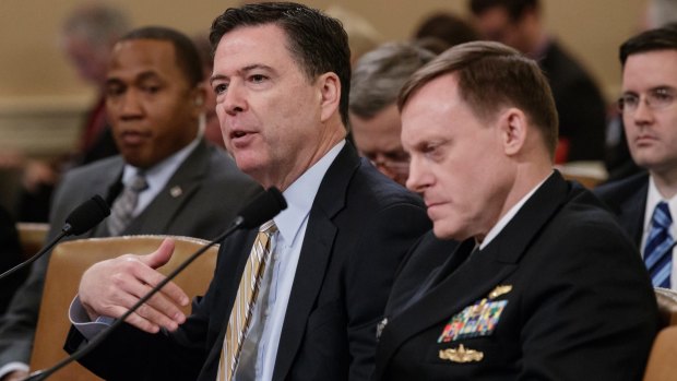 FBI director James Comey, left, and National Security Agency director Michael Rogers testify on Capitol Hill.
