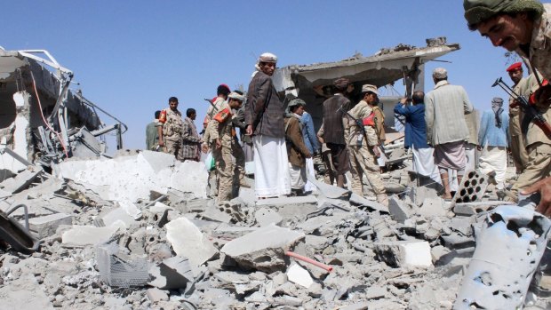 Soldiers and Houthi fighters inspect the damage caused by air strikes on the airport of Yemen's northwestern city of Saada, a Houthi stronghold near the Saudi border, on Monday. 
