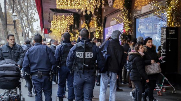 French police officers patrol outside the Galeries Lafayette department store in Paris.