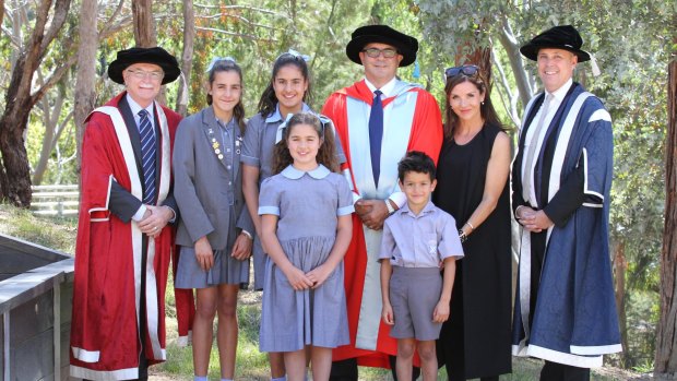 Andrew Demetriou and family pose with La Trobe deputy chancellor Dr Philip Moors AO (left) and vice-chancellor Professor John Dewar (right).