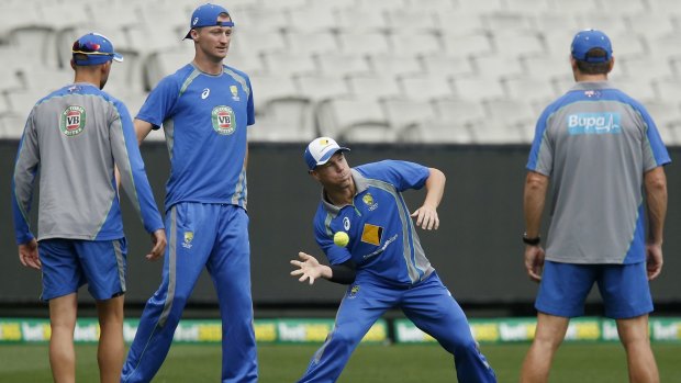 The players warm up at the MCG.