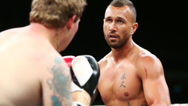 Quade Cooper and Jack McInnes fight during their heavyweight bout at Adelaide Oval.