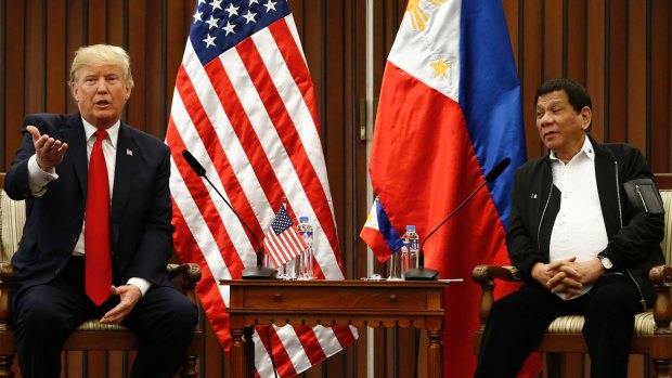 US President Donald Trump, left, gestures beside Philippine President Rodrigo Duterte during their meeting in Manila.