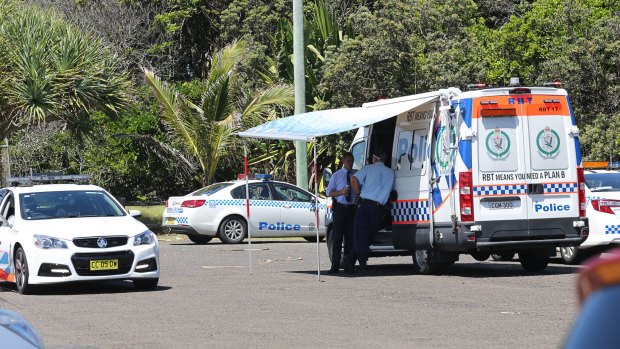 Police vehicles at Shelly Beach on Monday after a surfer was killed by a shark.
