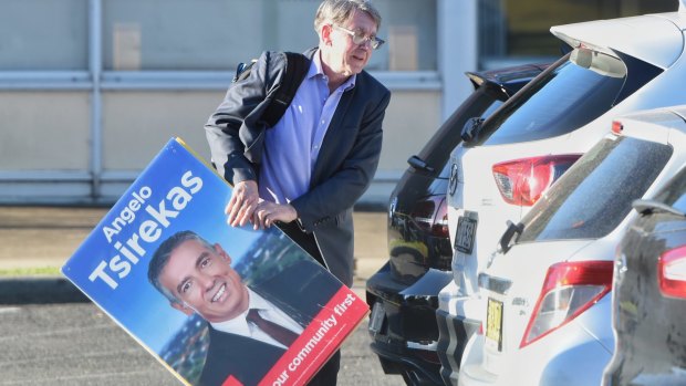 Andrew Ferguson with a placard of Labor's mayoral candidate for Canada Bay Angelo Tsirekas before the preselection meeting on Wednesday.