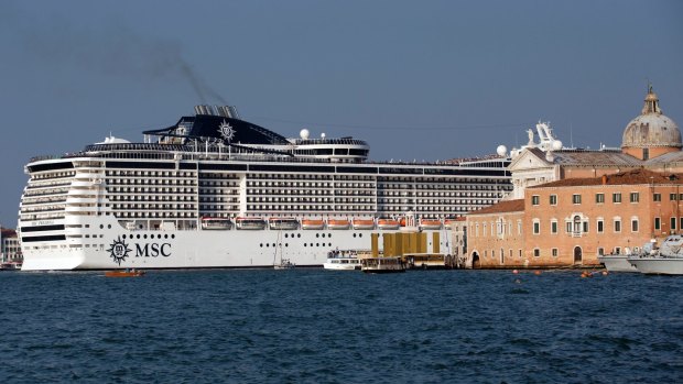 FILE - In this Sept. 27, 2014 file photo a cruise ship transits in the Giudecca canal, in The Italian government and Venice officials will to block giant cruise ships from steaming past the city's iconic St. Mark's Square and instead re-route them to a nearby industrial port. 