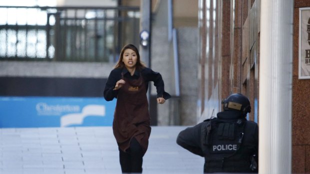 A waitress, believed to be Elly Chen, flees Lindt cafe on Monday afternoon. 
