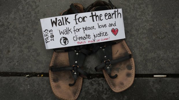 A message saying "Walk for the earth" is seen on a pair of shoes, as hundreds of pairs of shoes are displayed at the Place de la Republique in Paris before the climate change summit.