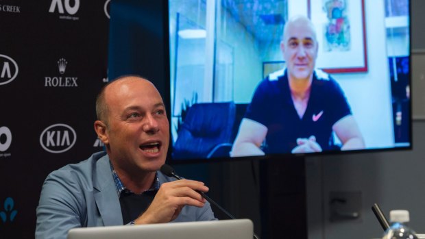 Giuseppe Lavazza (left) hosting a press conference with Andre Agassi, on screen, at the Australian Open on Saturday. 