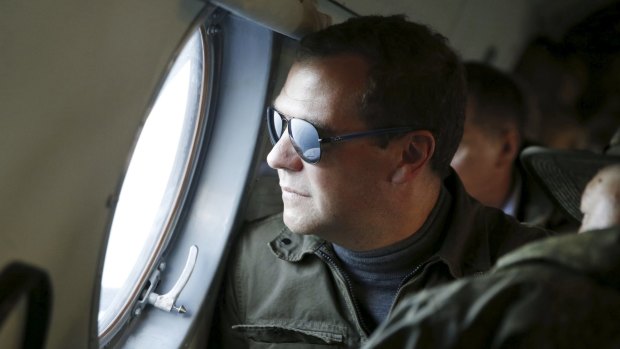 Russia's Prime Minister Dmitry Medvedev looks out a window of an aircraft during his visit to Iturup Island, one of four islands known as the Southern Kurils in Russia and the Northern Territories in Japan.