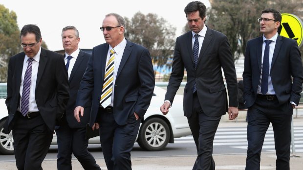 AFL boss Gillon McLachlan (second from right) arrives at the memorial service for Phil Walsh 