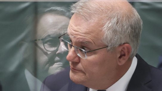 Reflection of Opposition Leader Anthony Albanese seen on the perspex screen, and Prime Minister Scott Morrison during Question Time at Parliament House in Canberra on Monday 29 November 2021. fedpol Photo: Alex Ellinghausen