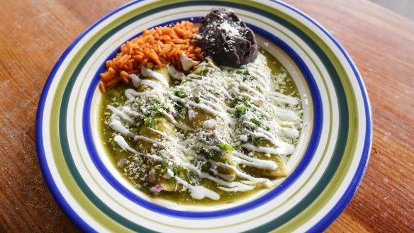 Chicken enchiladas with green mole sauce.