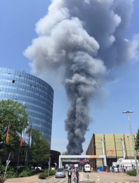 Smoke rises from the building housing migrants in Dusseldorf which was destroyed by fire on Wednesday.