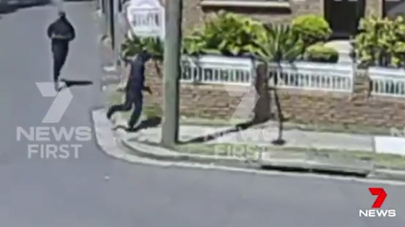 Two men running from the scene of a burning car that could be linked to the shooting.